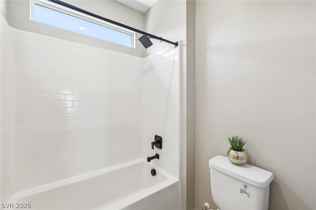194 Viento Ridge Street, Henderson, NV 89012 Crisp subway tile surrounds the built-in tub under a high window.