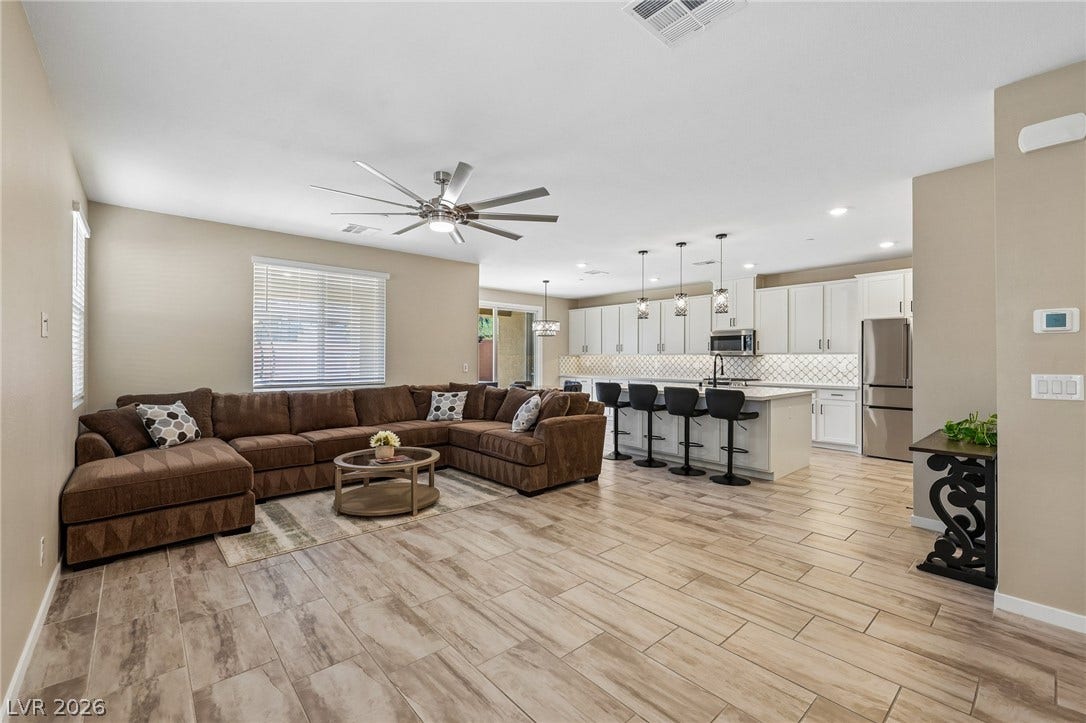 194 Viento Ridge Street, Henderson, NV 89012 Gleaming tile floors stretch across a seamless layout connecting the living and kitchen spaces.