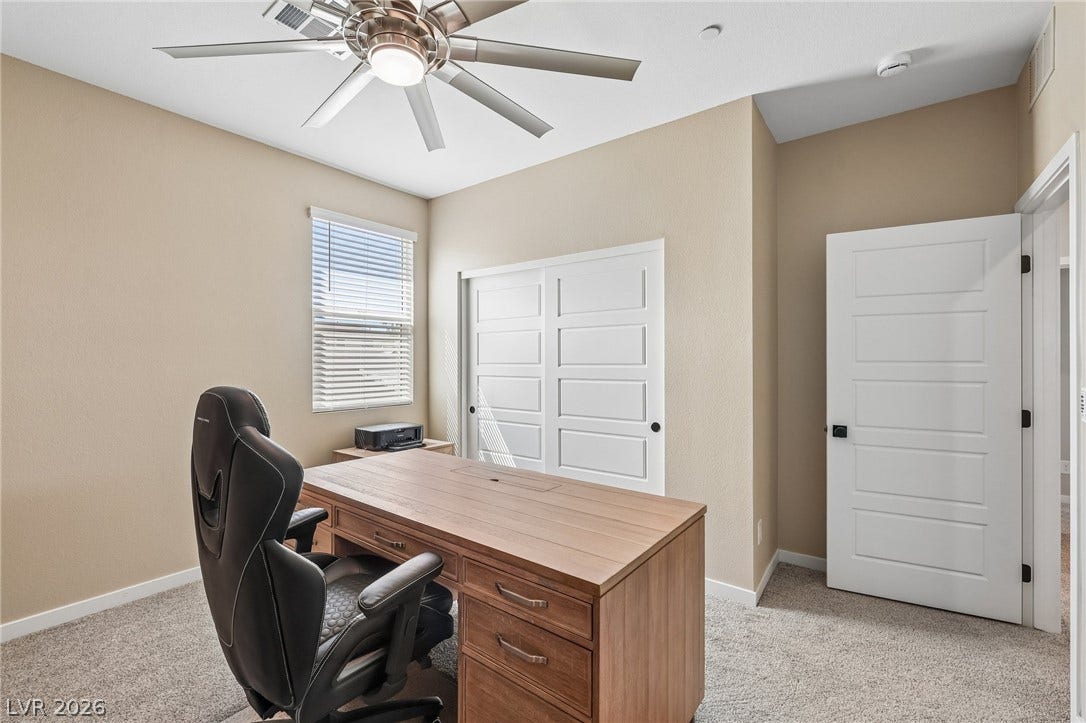194 Viento Ridge Street, Henderson, NV 89012 A quiet home workspace stands ready with neutral walls and soft plush carpeting.