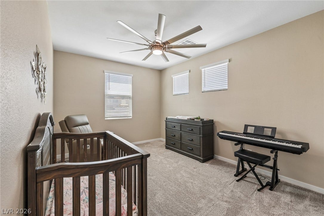 194 Viento Ridge Street, Henderson, NV 89012 Soft carpeting pairs with neat trim in this comfortable secondary bedroom.