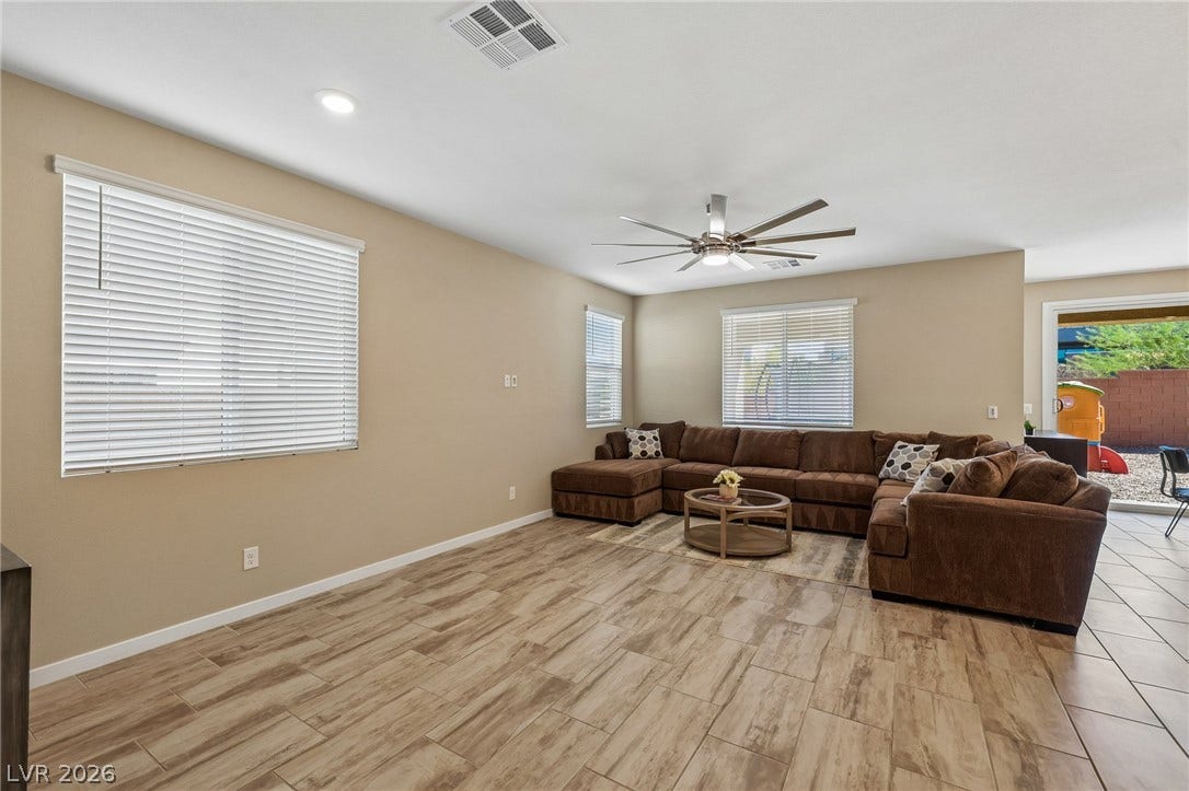 194 Viento Ridge Street, Henderson, NV 89012 Gleaming wood-look tile floors run throughout this versatile open-plan living area.