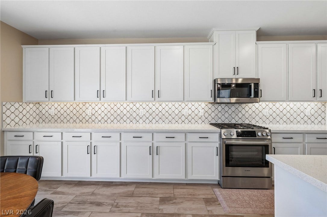 194 Viento Ridge Street, Henderson, NV 89012 Gleaming stone counters and patterned tile backsplashes define this cook space.