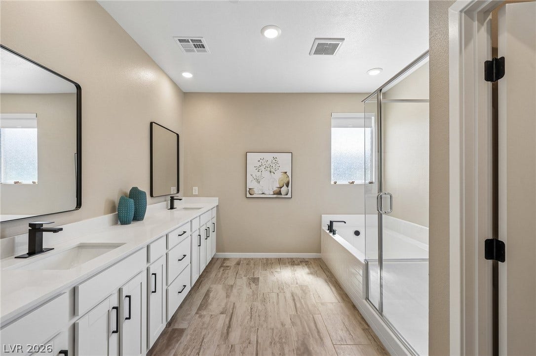 194 Viento Ridge Street, Henderson, NV 89012 Double vanities, a soaking tub, and a separate glass shower highlight this master bath.