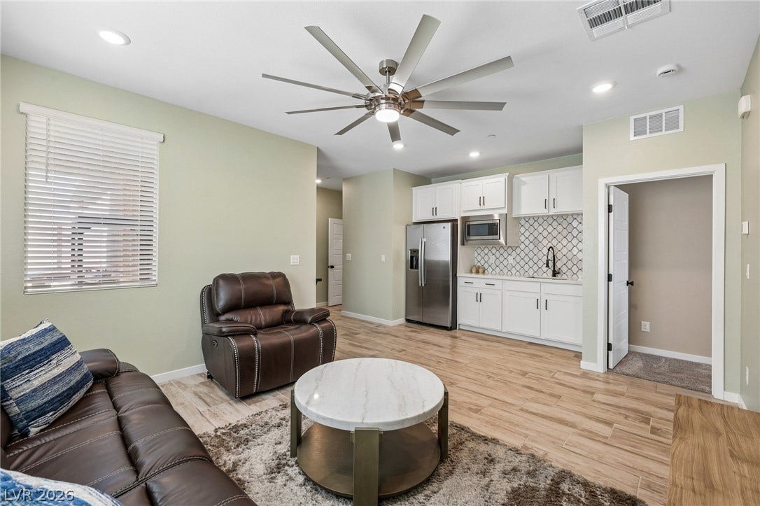 194 Viento Ridge Street, Henderson, NV 89012 Plank flooring and an open layout connect the casual living space to a modern wet bar.