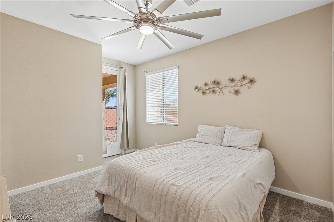 194 Viento Ridge Street, Henderson, NV 89012 Plush carpeting and private outdoor access define this comfortable bedroom space.