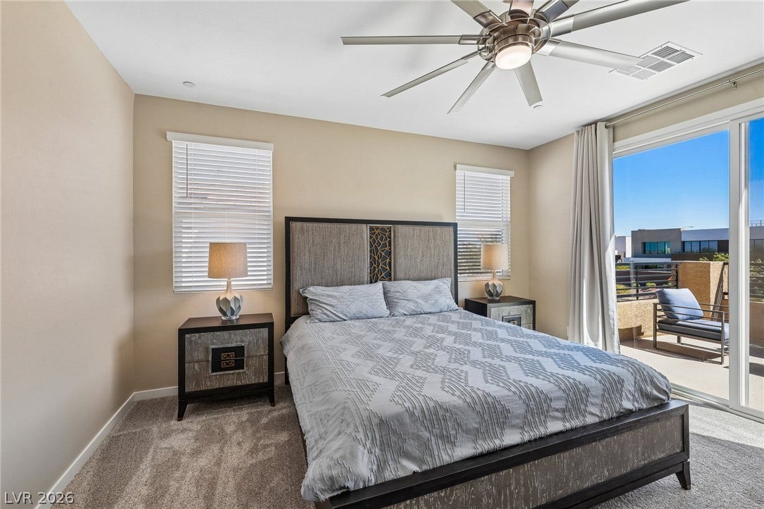 194 Viento Ridge Street, Henderson, NV 89012 Sliding glass doors open from this carpeted bedroom directly onto a private balcony.