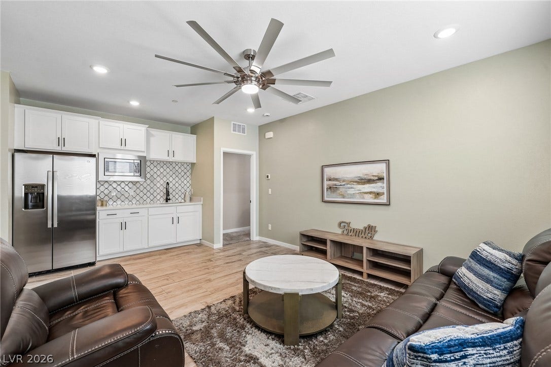 194 Viento Ridge Street, Henderson, NV 89012 Gleaming hardwood floors and a handy wet bar anchor this versatile open living space.