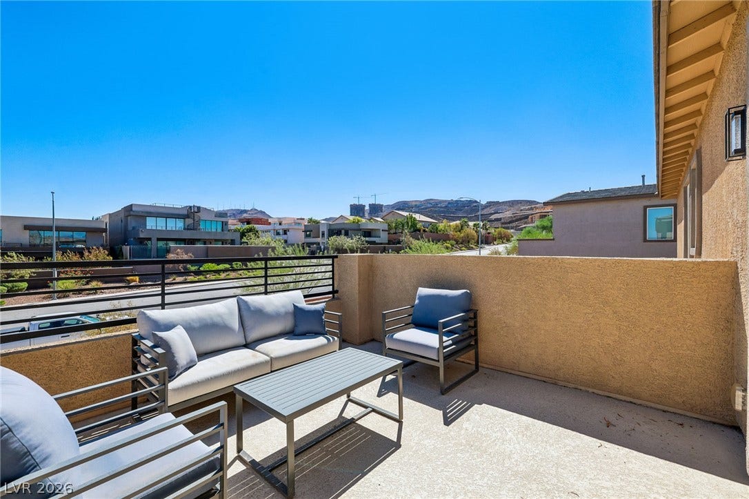 194 Viento Ridge Street, Henderson, NV 89012 An open balcony space features concrete flooring and railing borders with far-reaching neighborhood vistas.