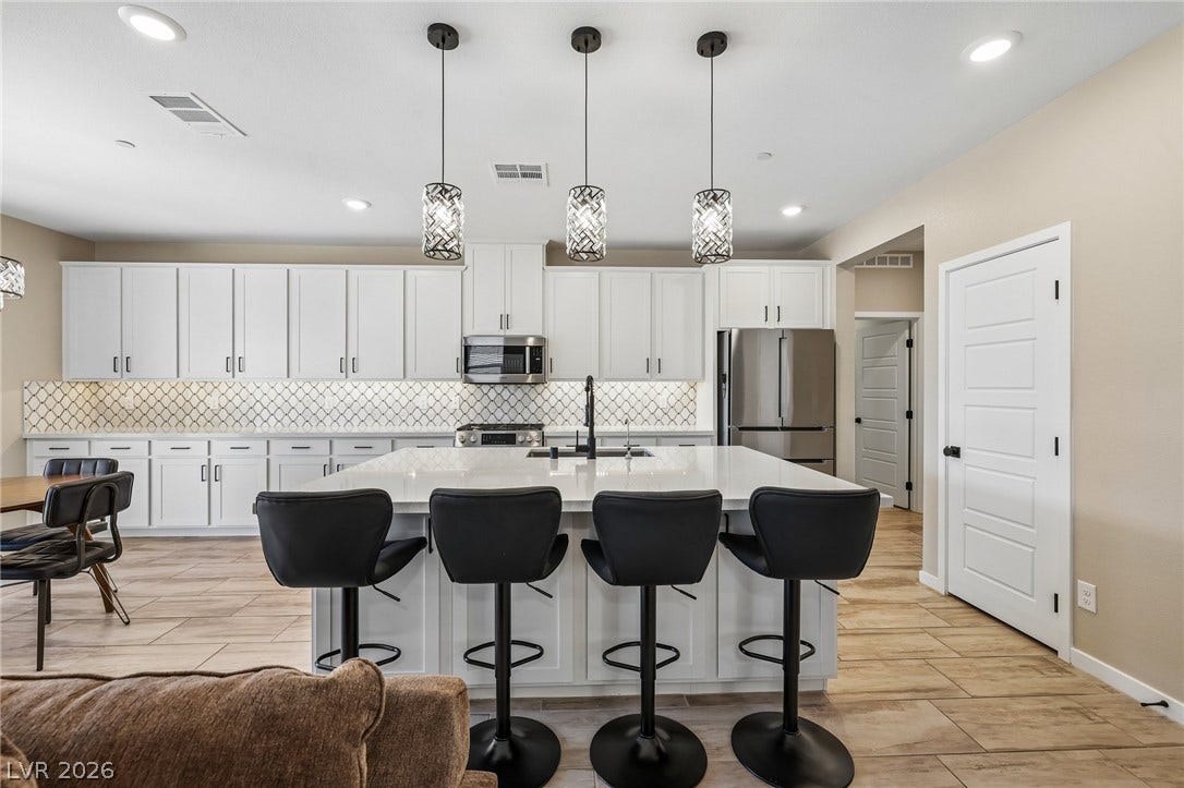 194 Viento Ridge Street, Henderson, NV 89012 Plentiful cabinetry and a generous center island define this modern culinary workspace.