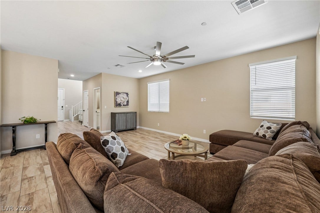 194 Viento Ridge Street, Henderson, NV 89012 An open-concept living area features durable tile flooring and abundant natural light from large windows.