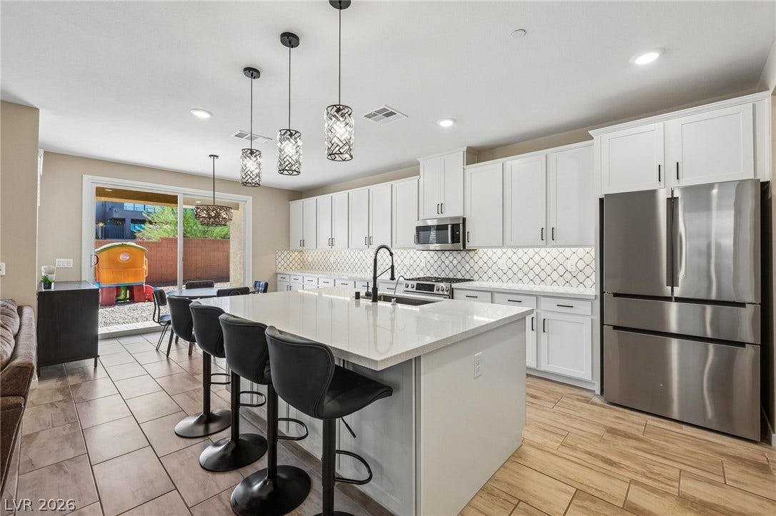 194 Viento Ridge Street, Henderson, NV 89012 An expansive central island highlights this culinary space with sleek stone countertops.