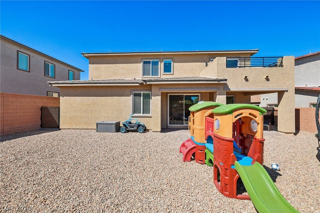 194 Viento Ridge Street, Henderson, NV 89012 An expansive gravel backyard highlights the rear exterior of this two-story stucco residence.