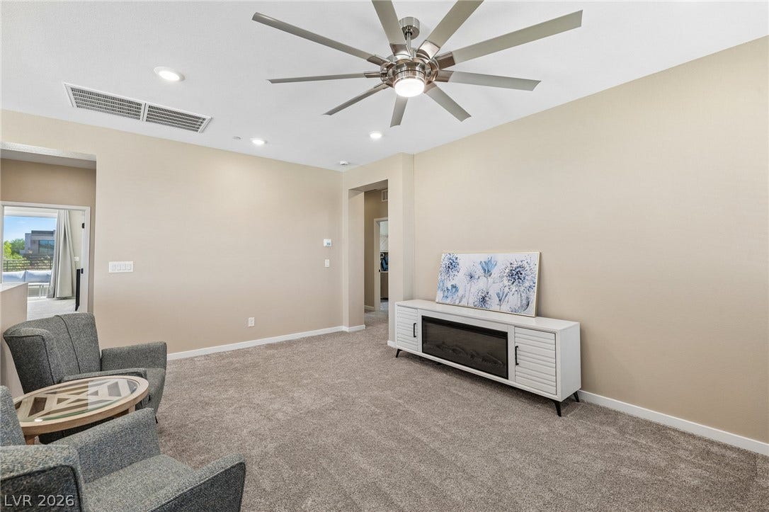 194 Viento Ridge Street, Henderson, NV 89012 Recessed lighting and soft carpeting create a cozy ambiance in this inviting living space.