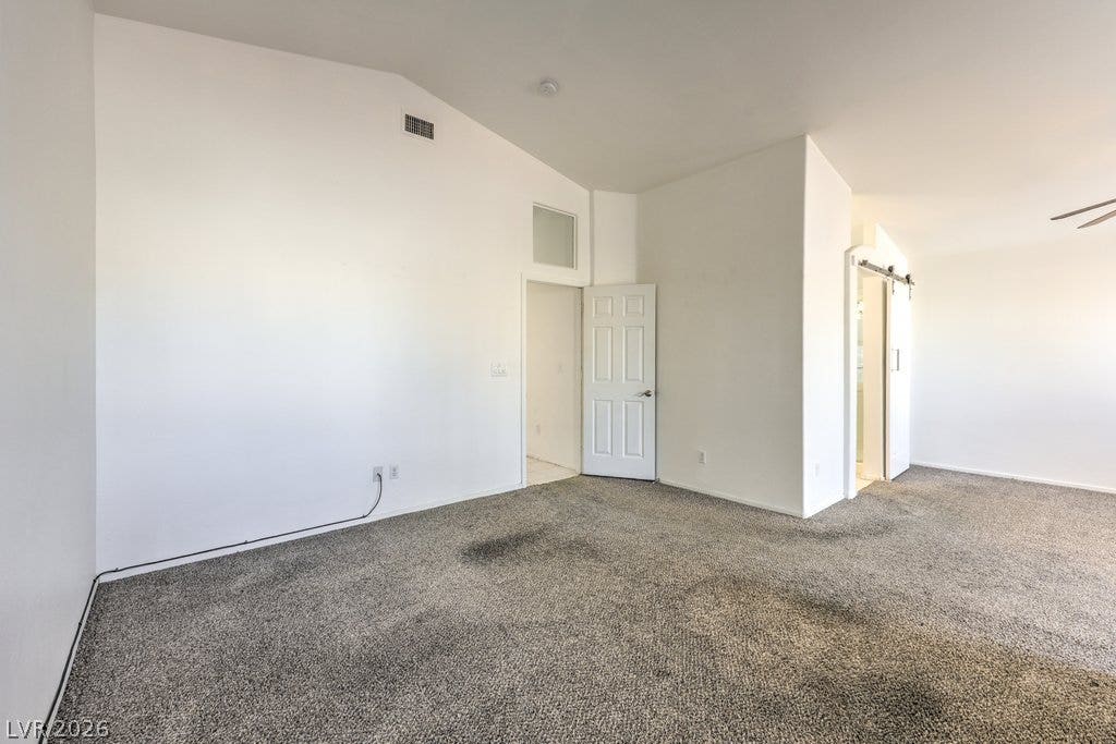 3186 CASTLE CANYON Avenue, Henderson, NV 89052 Vaulted ceilings and soft carpeting define this versatile living space.
