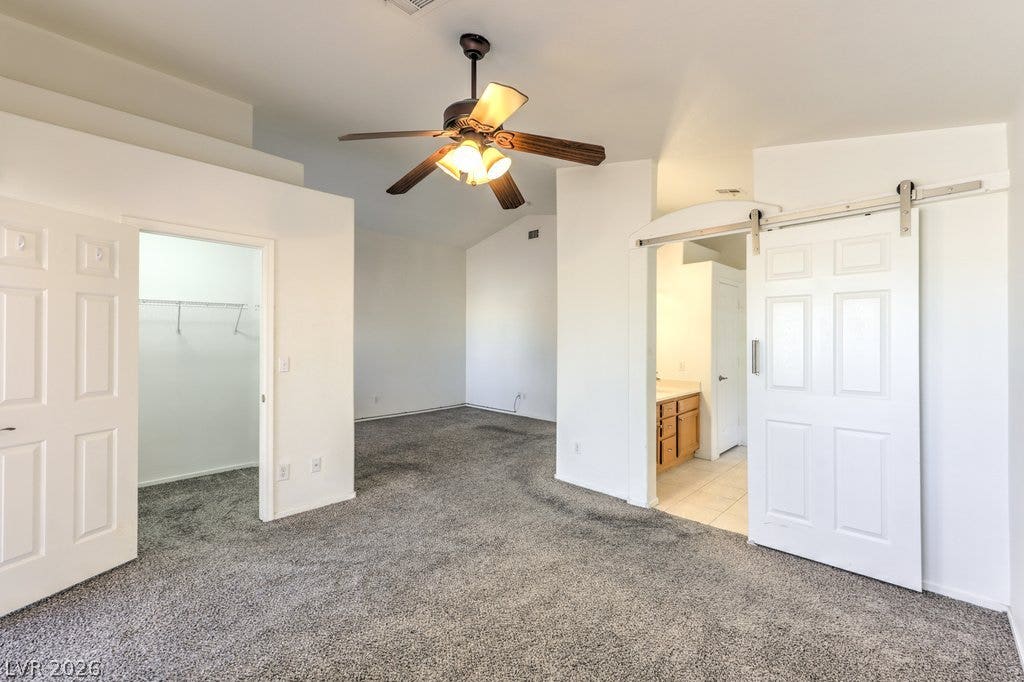3186 CASTLE CANYON Avenue, Henderson, NV 89052 Vaulted ceilings and soft plush carpeting define this spacious primary bedroom suite.
