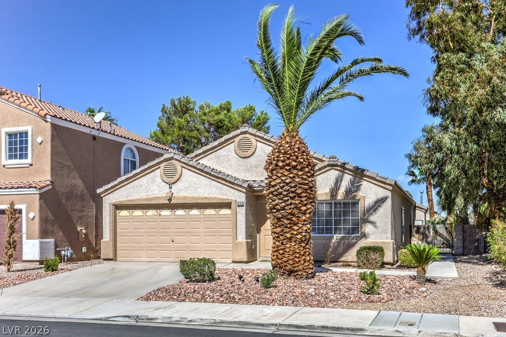 3186 CASTLE CANYON Avenue, Henderson, NV 89052 Classic desert landscaping accents this charming stucco single-family home with an attached garage.