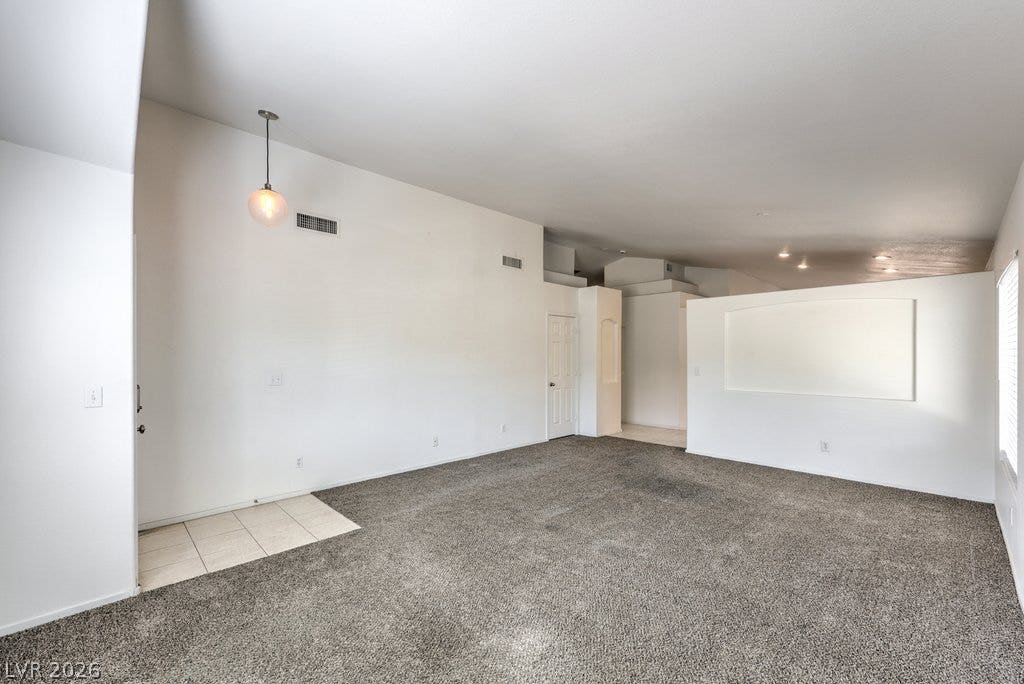 3186 CASTLE CANYON Avenue, Henderson, NV 89052 High ceilings and neutral carpet define this open interior layout.