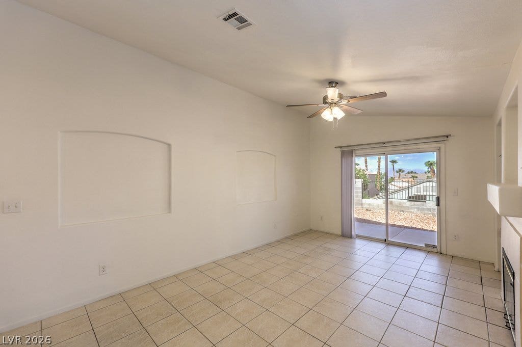 3186 CASTLE CANYON Avenue, Henderson, NV 89052 Tiled flooring and a sliding glass door define this versatile living space.