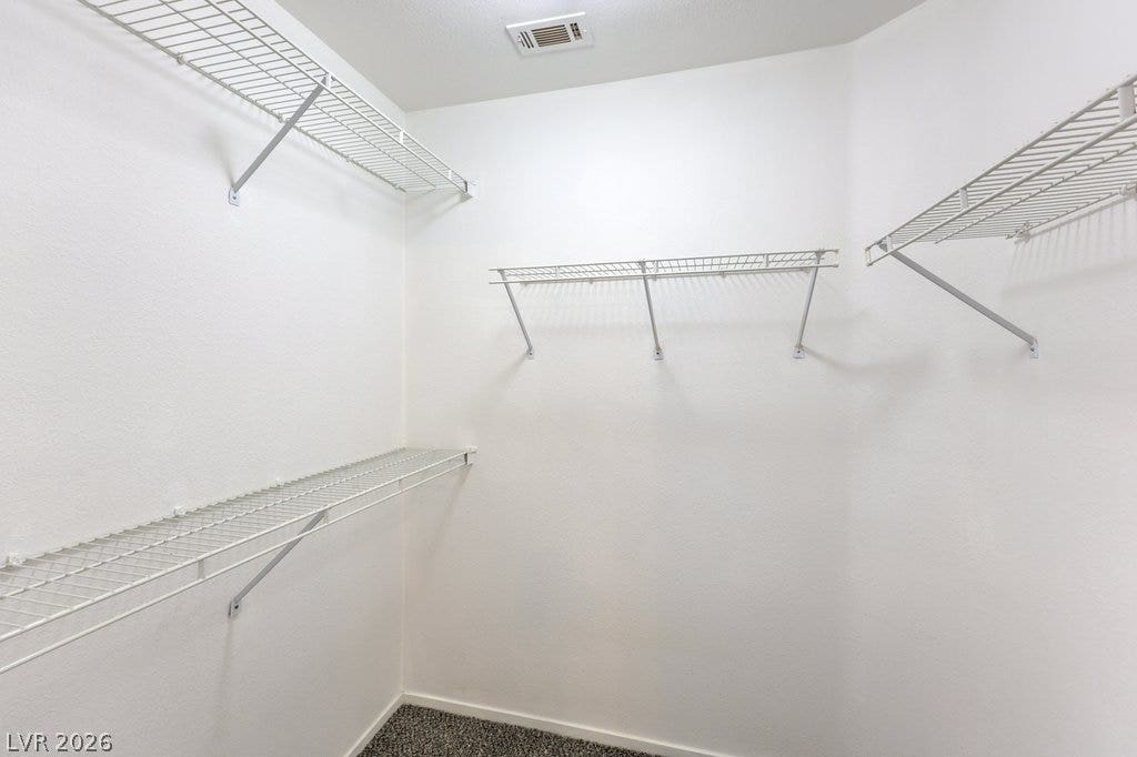 3186 CASTLE CANYON Avenue, Henderson, NV 89052 Generous closet space featuring practical wire shelving and neutral carpeting.