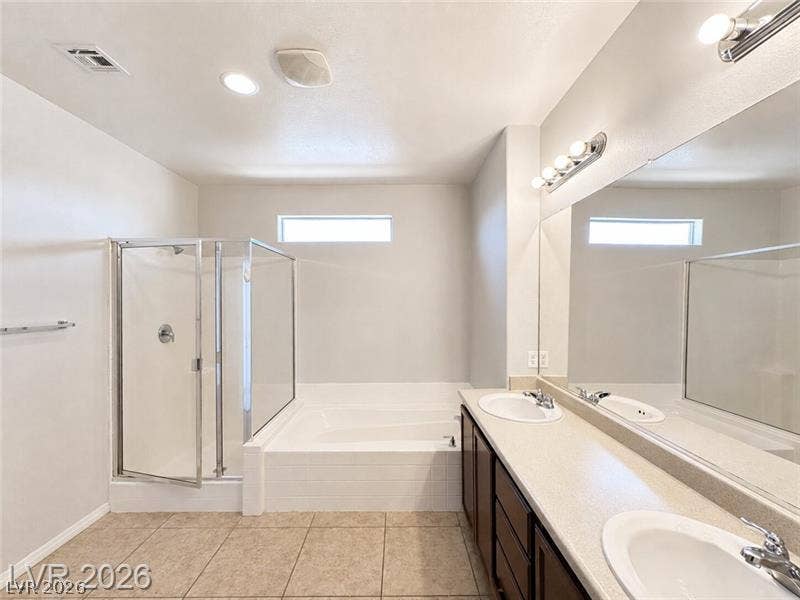 4020 Thomas Patrick Avenue, North Las Vegas, NV 89032 Tiled floors and clean lines define this bathroom featuring a separate shower and soaking tub.