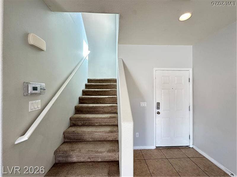 4020 Thomas Patrick Avenue, North Las Vegas, NV 89032 Tiled flooring greets visitors at the entrance foyer beside carpeted stairs.