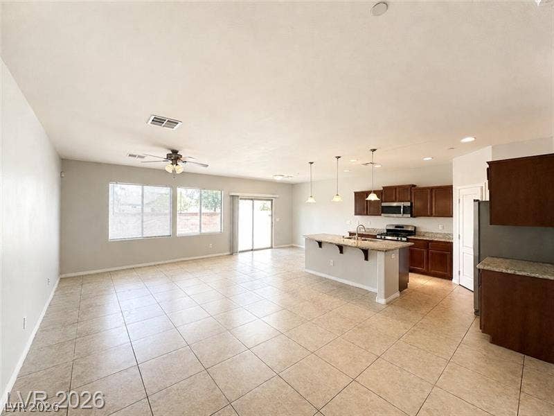 4020 Thomas Patrick Avenue, North Las Vegas, NV 89032 Tiled flooring anchors this open layout connecting a casual living space to the kitchen.
