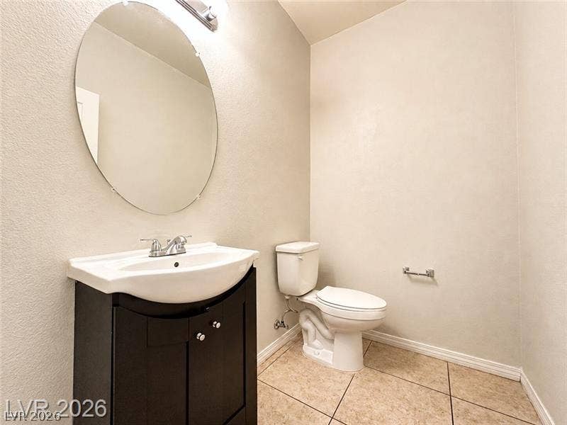 4020 Thomas Patrick Avenue, North Las Vegas, NV 89032 Tiled flooring and a modern dark vanity highlight this clean powder room.