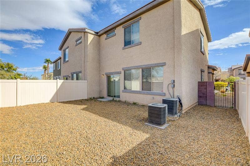 4020 Thomas Patrick Avenue, North Las Vegas, NV 89032 A fenced backyard features low-maintenance gravel landscaping along the rear stucco exterior.