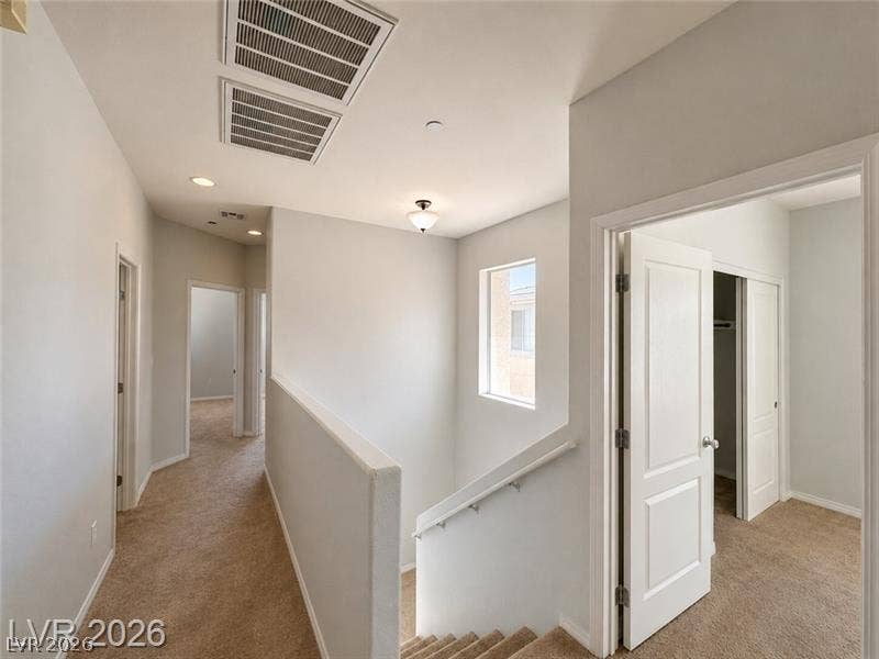 4020 Thomas Patrick Avenue, North Las Vegas, NV 89032 An upper landing features neutral carpeted flooring and leads to multiple bedrooms.