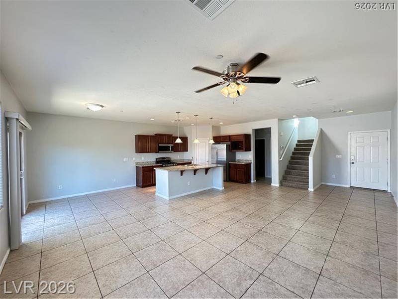 4020 Thomas Patrick Avenue, North Las Vegas, NV 89032 An open-concept living area seamlessly connects to the kitchen with tile floors throughout.