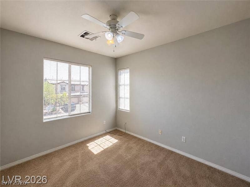 4020 Thomas Patrick Avenue, North Las Vegas, NV 89032 Natural light streams across soft carpeting in this versatile secondary bedroom.