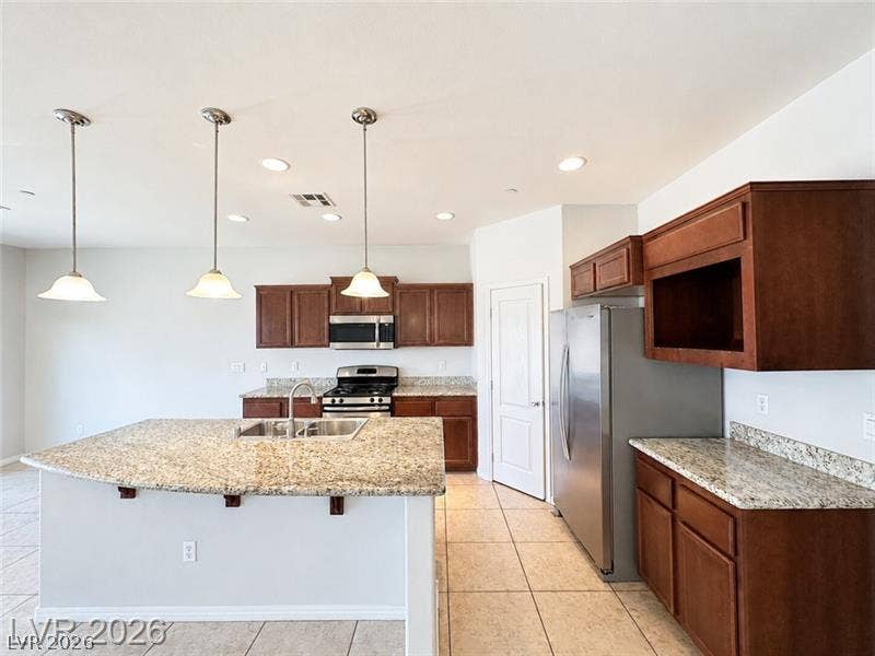 4020 Thomas Patrick Avenue, North Las Vegas, NV 89032 Rich wood cabinetry contrasts beautifully with granite countertops in this culinary workspace.