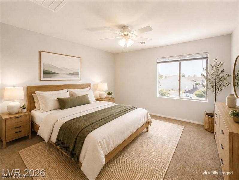 4020 Thomas Patrick Avenue, North Las Vegas, NV 89032 Plentiful natural light fills this bedroom featuring plush carpeting and a large view window.