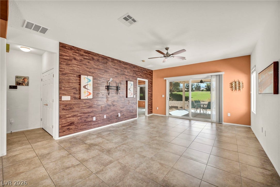 Tiled flooring and sliding glass doors leading outside define this versatile open living area.