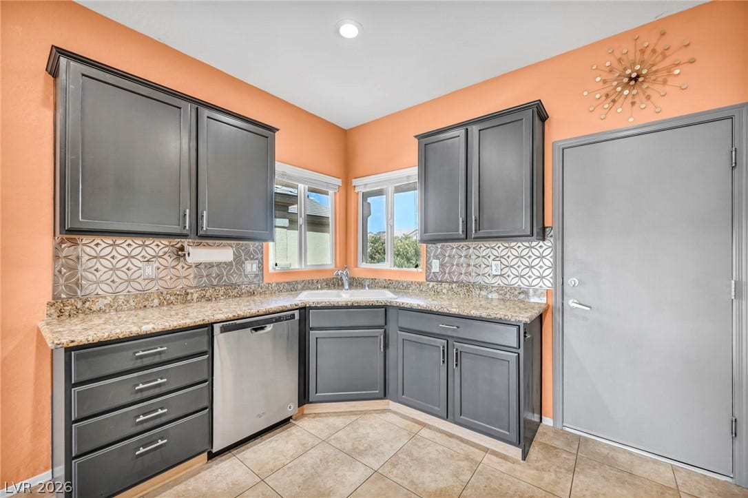 Richly toned cabinetry and polished stone countertops elevate this functional kitchen space.