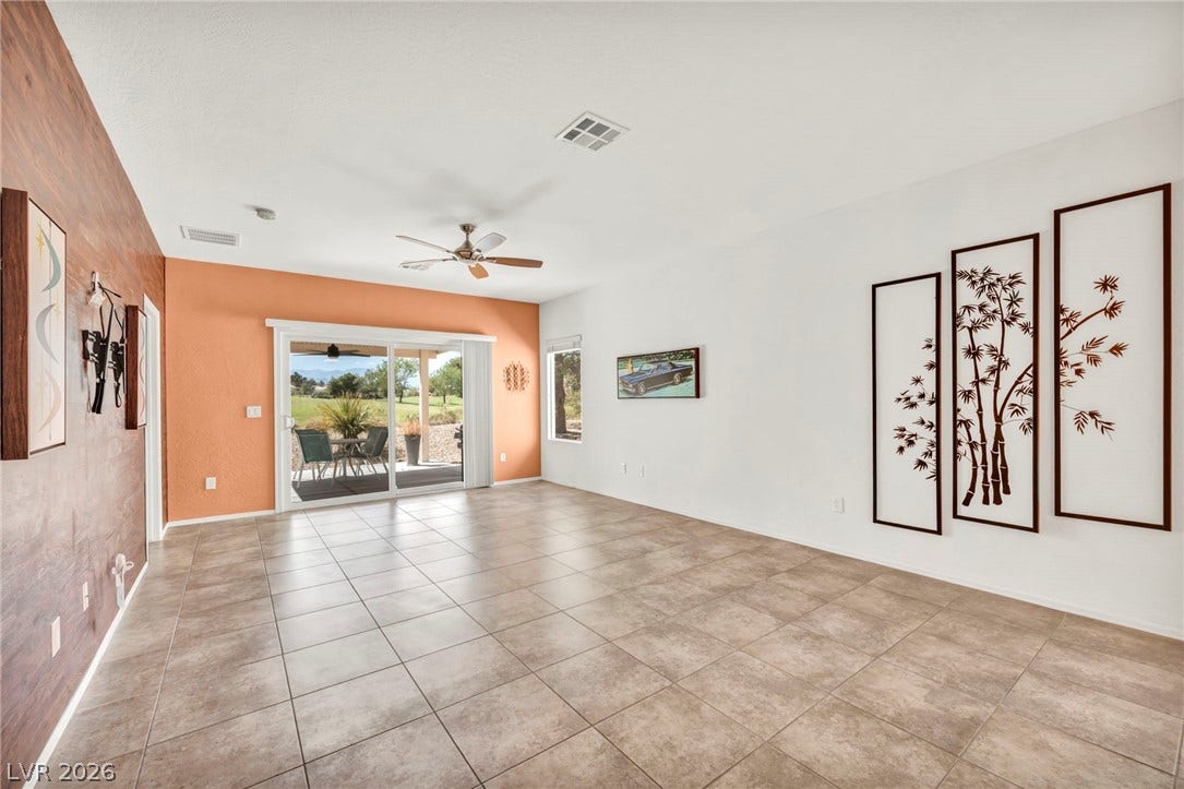 Tiled flooring and sliding glass doors leading to the patio define this open living space.