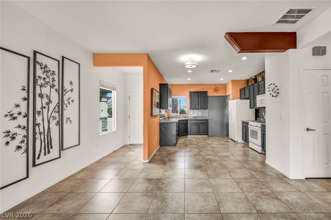 An open layout flows seamlessly from the tile-floored dining area into the kitchen.