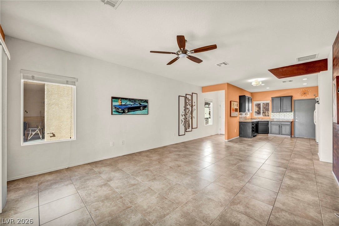 Ceramic tile floors guide the eye through an open layout connecting living spaces to the kitchen.