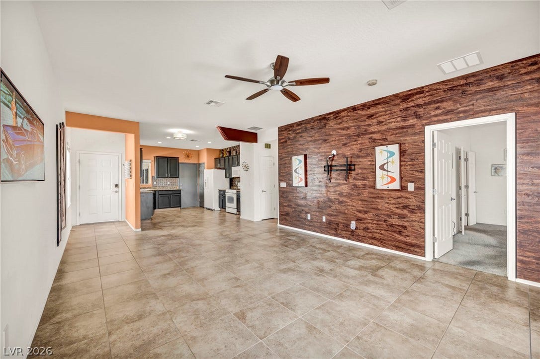 An open layout connects the tiled living space directly to the kitchen area.