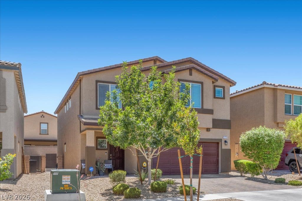 A welcoming facade showcases a well-maintained exterior with mature landscaping and a functional attached garage.