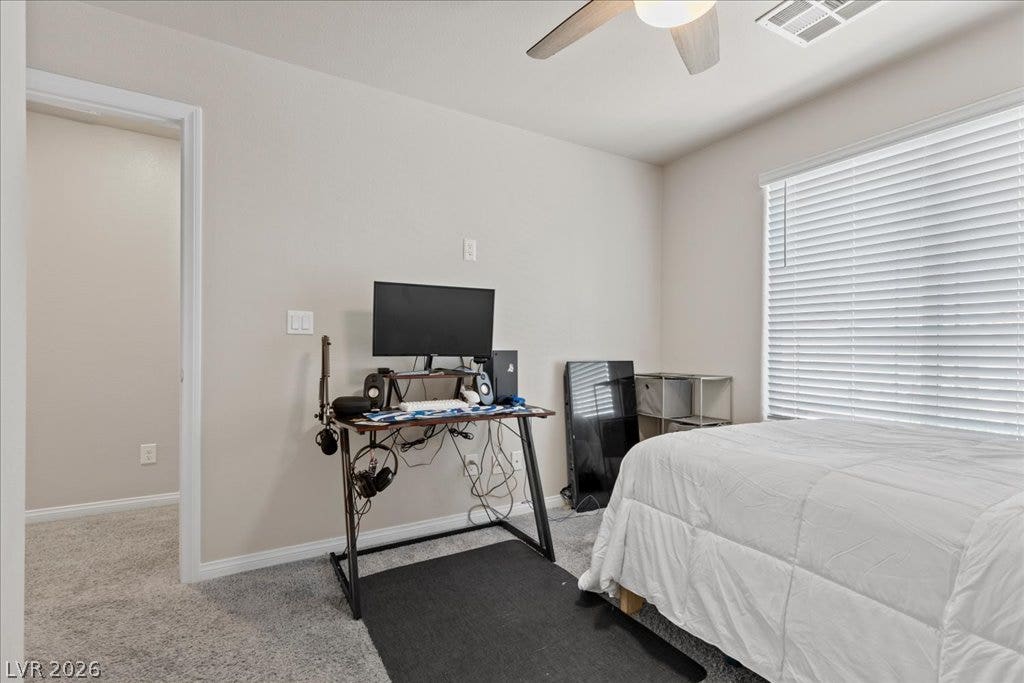 A quiet bedroom offering comfort and a functional workspace.