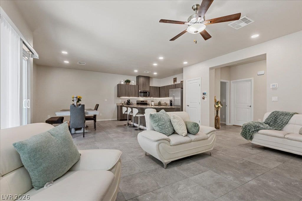 An open concept living area seamlessly connects to a contemporary kitchen, perfect for effortless entertaining.
