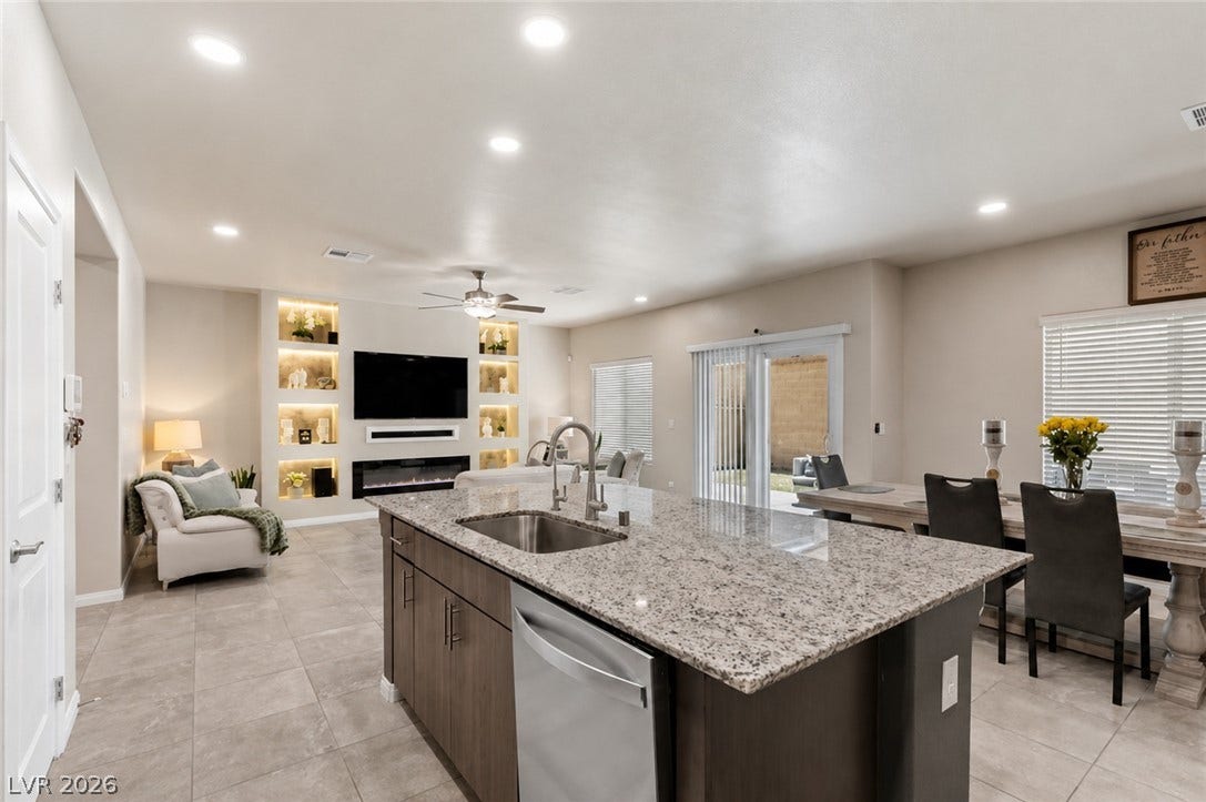 A flowing layout features an inviting kitchen island with a spacious granite countertop.