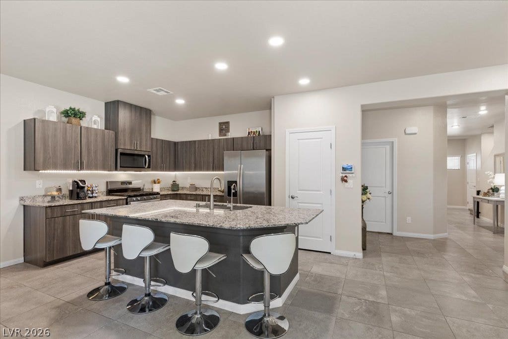 Culinary delights await in this modern kitchen with ample counter space and efficient appliances.