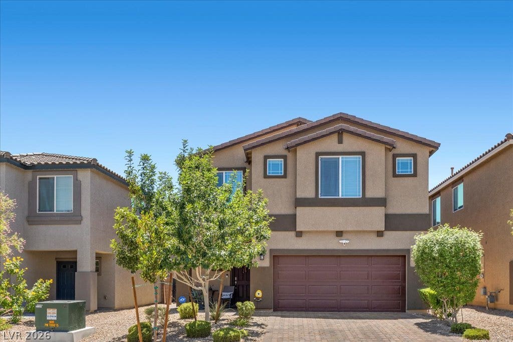A well-maintained facade with an attached garage and desert-friendly landscaping welcomes residents.