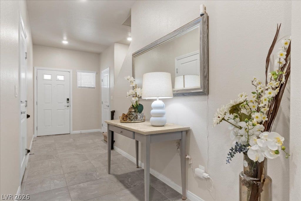 Step into this welcoming entryway featuring durable tile flooring and soft recessed lighting.