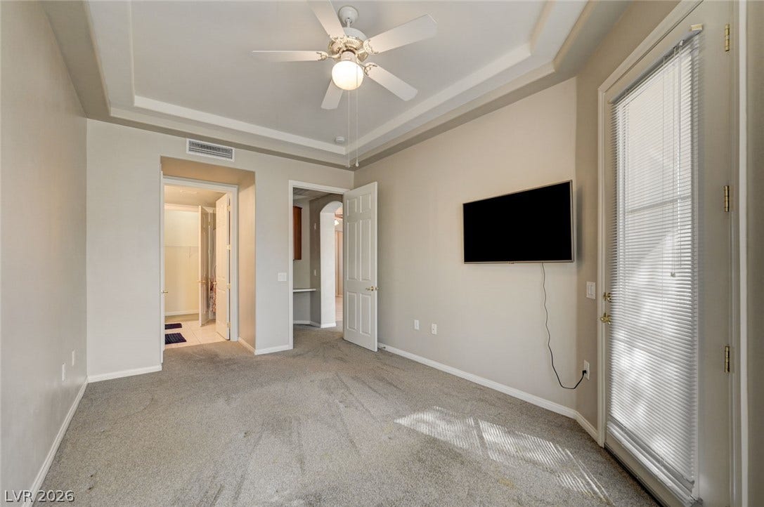 207 Kaelyn Street, #5, Boulder City, NV 89005 An elegant tray ceiling and soft carpeting define this inviting space.