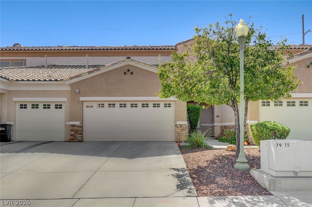 207 Kaelyn Street, #5, Boulder City, NV 89005 A spacious driveway and multi-car garage provide ample parking beneath classic tile roofing.
