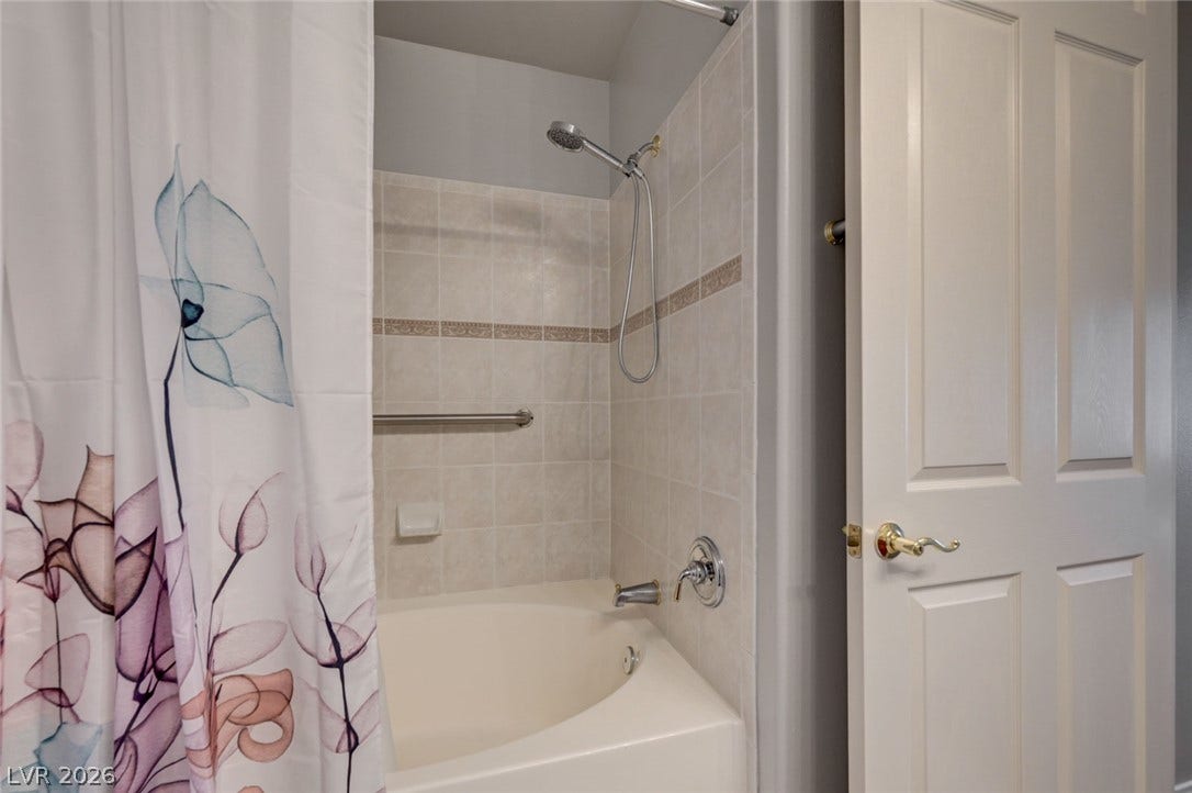 207 Kaelyn Street, #5, Boulder City, NV 89005 Tiled shower walls surround a deep soaking tub in this functional bathroom space.