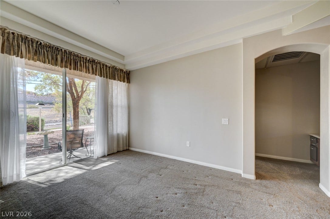 207 Kaelyn Street, #5, Boulder City, NV 89005 Sliding glass doors open to the outdoor patio from this carpeted living area.